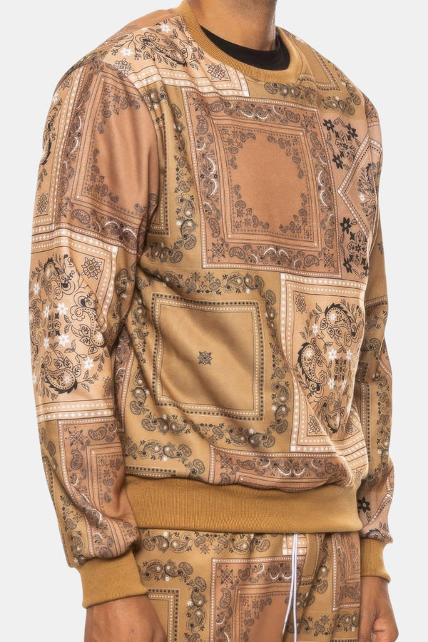 KIOKO Crenshaw paisley bandana print crewneck sweatshirt in khaki with long sleeves and ribbed cuffs on a model