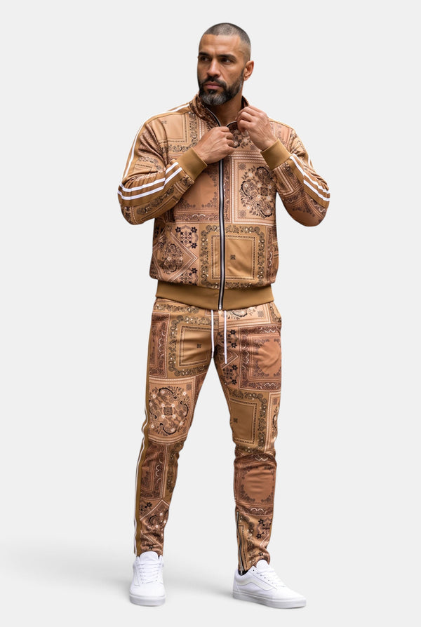 KIOKO Crenshaw paisley bandana track jacket in khaki with matching joggers worn by a man on a white background