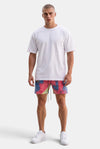 KIOKO Cypher tie-dye jogger shorts in blue, pink, and yellow cotton with an elastic drawstring waist on a male model.