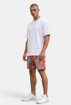 KIOKO Cypher tie-dye jogger shorts in red and blue worn by a model with a white t-shirt and sneakers