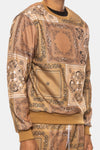 KIOKO Crenshaw paisley bandana print crewneck sweatshirt in khaki with long sleeves and ribbed cuffs on a model