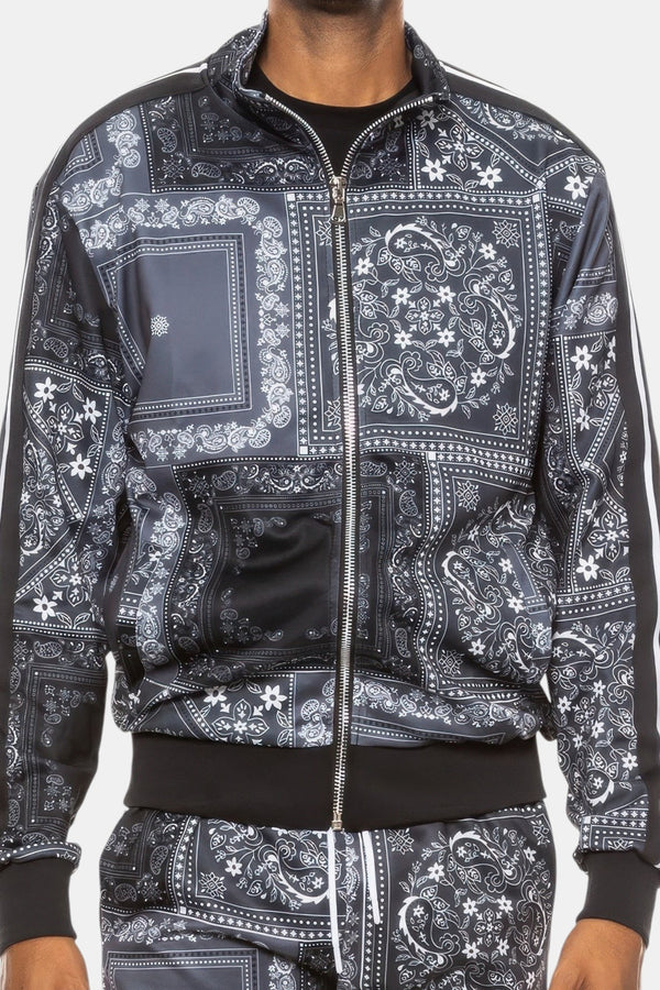 KIOKO Crenshaw Paisley Bandana Track Jacket in black with a full-zip front and all-over white paisley print pattern.