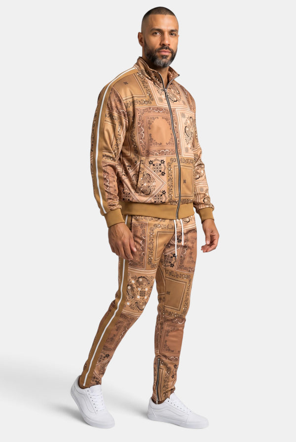 KIOKO Crenshaw paisley bandana track jacket and matching pants in khaki with white side stripes worn by a man