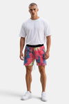 KIOKO Cypher tie-dye jogger shorts in blue and pink with an elastic drawstring waistband worn by a male model.