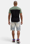 KIOKO Eastside colorblock t-shirt in olive and black worn by a man from the back view with denim cargo shorts