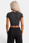 KIOKO Hustle Culture crop top in washed charcoal grey cotton, back view on a blonde model with black sweatpants.