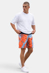 KIOKO model wearing red and blue tie-dye cotton jogger shorts with an elastic drawstring waist and relaxed fit