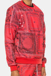 KIOKO red crewneck sweatshirt featuring a bold paisley bandana print with ribbed cuffs and a classic round neckline