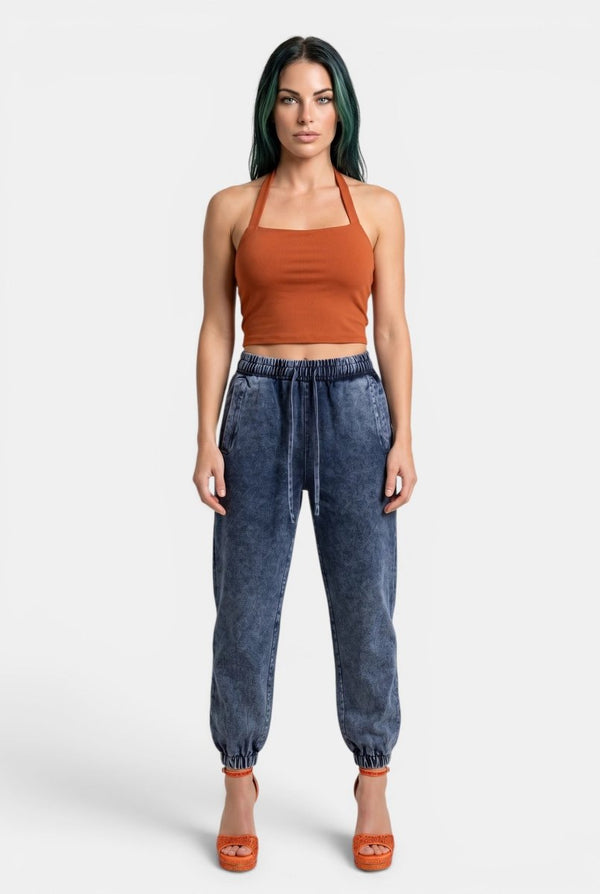 KIOKO Sculpt & Slay halter sports bra in rust orange, worn by a model with dark hair against a neutral background.
