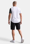 KIOKO Steeze Camo Colorblock T-shirt in white with camo sleeve, worn by a man from the back view with black shorts.